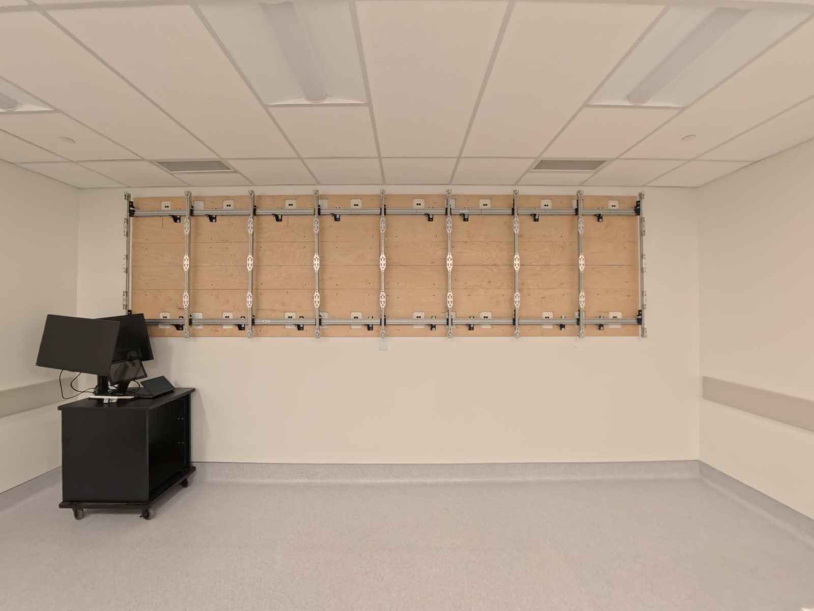 Plywood backer and mounting rails for a direct-view LED wall before the modules go on