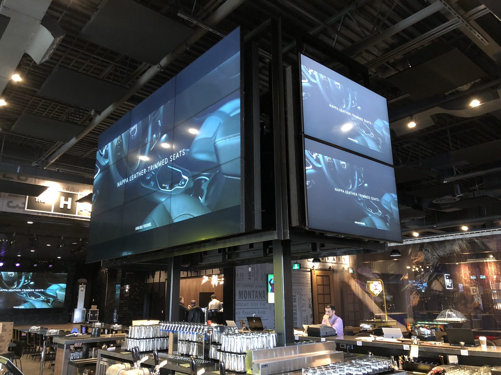 Video walls above a bar in an entertainment venue